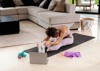 Mulher praticando pilates com orientação online.