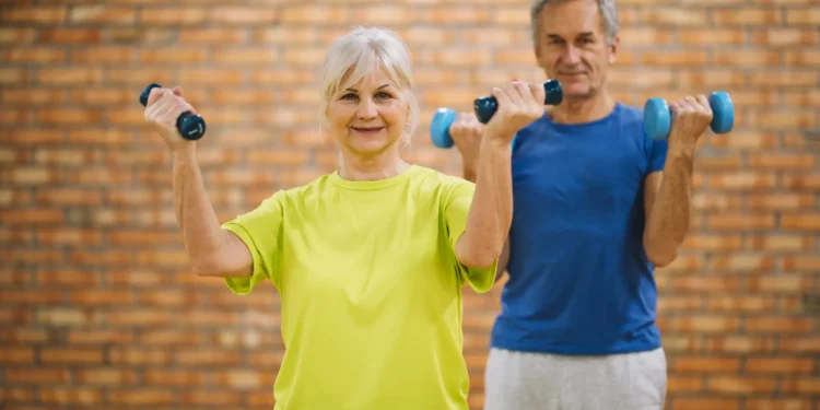 Idosos praticando exercício com halteres para manter a força muscular
