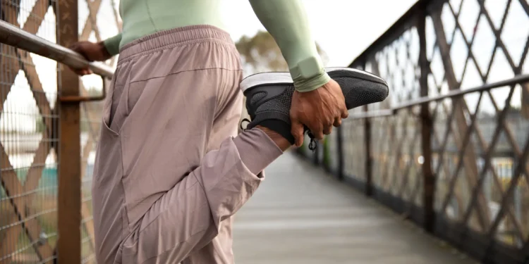 Homem fazendo alongamento diário em ponte ao ar livre
